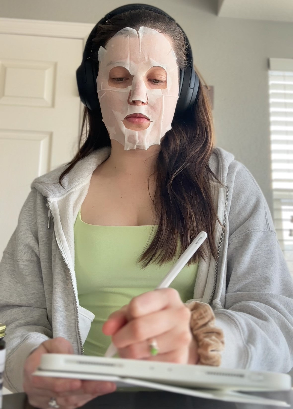 woman wearing a face mask and headphones influencer skincare